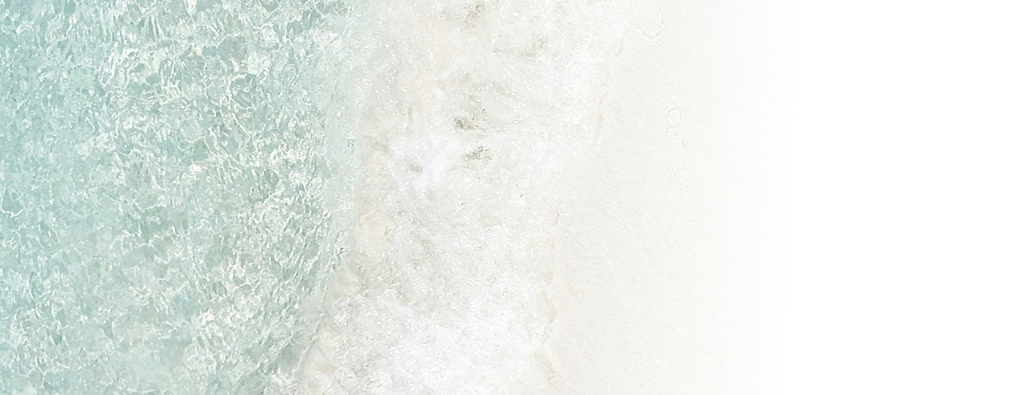 Waves gently crashing on sandy beach shore.