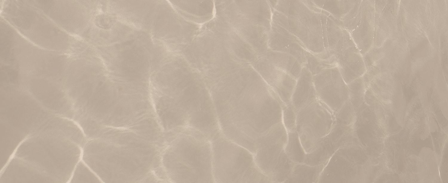 Rippling water surface in soft beige tones.