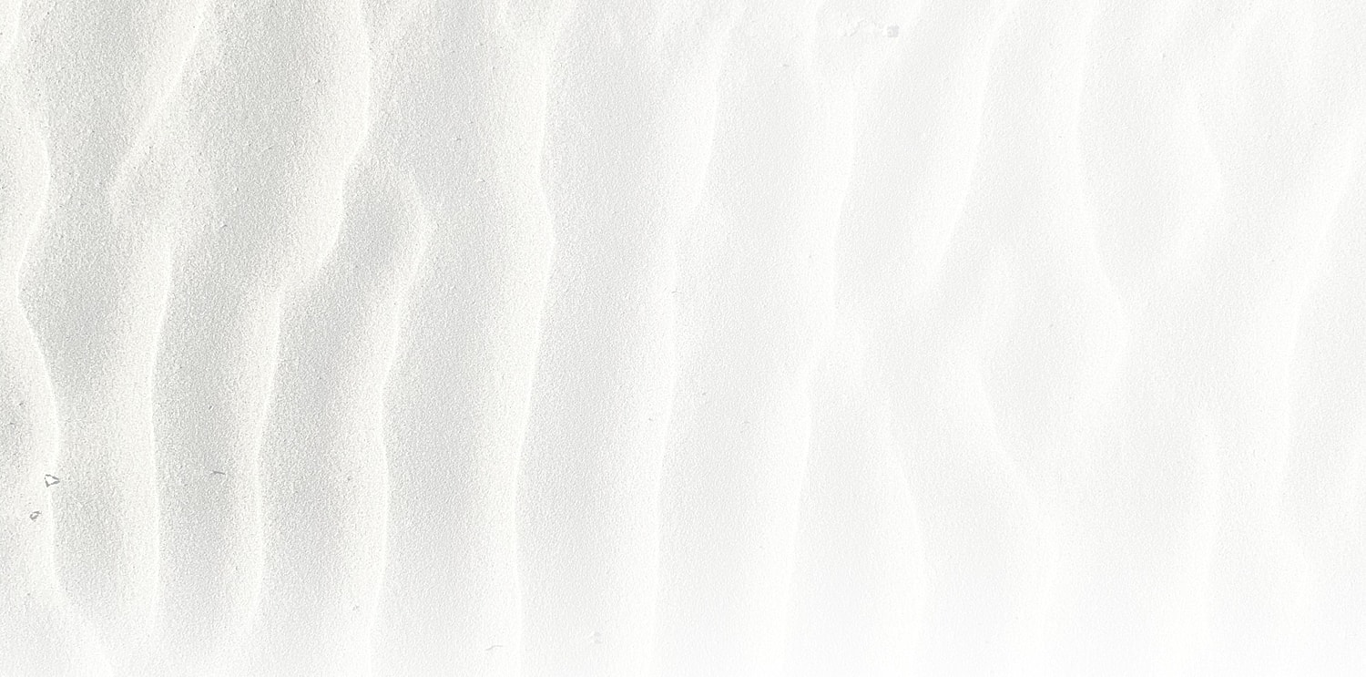 White sand texture with soft waves.