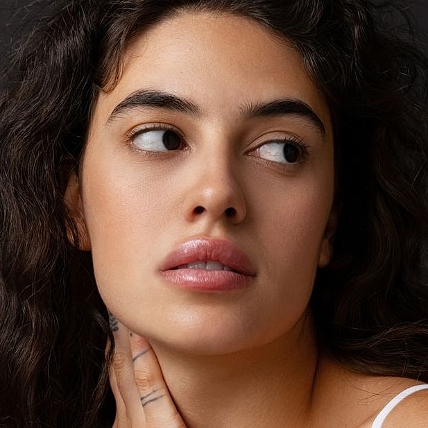 Close-up of a woman with curly hair.