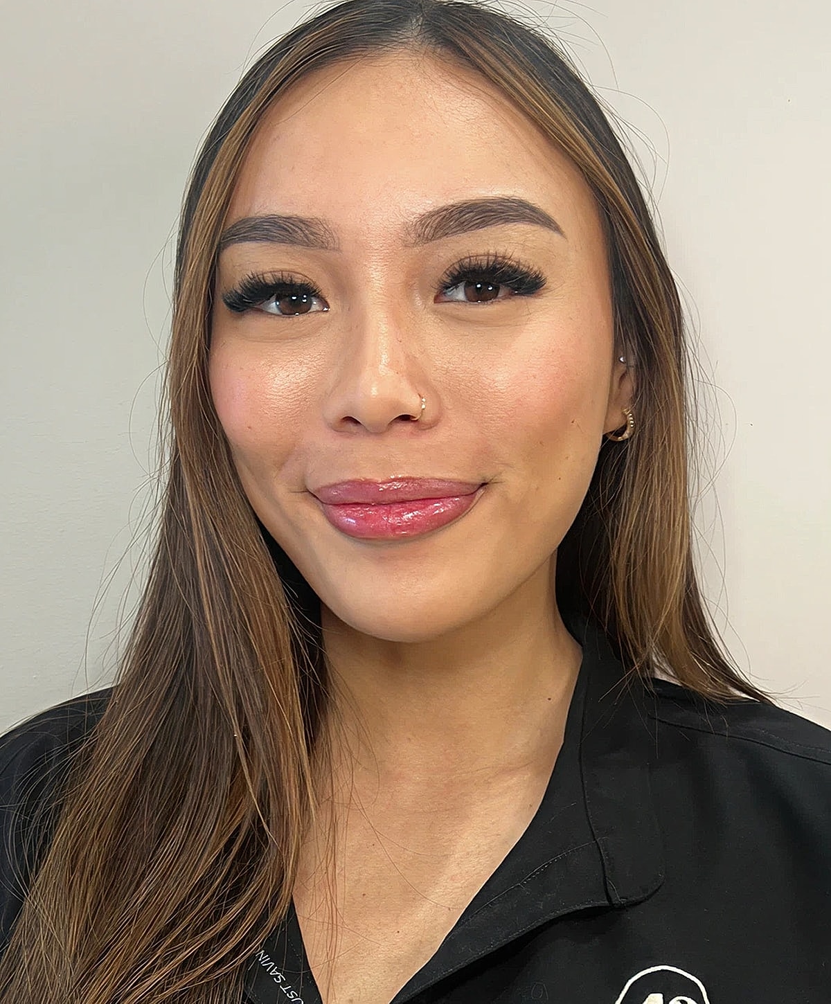 Smiling woman with long, straight hair.