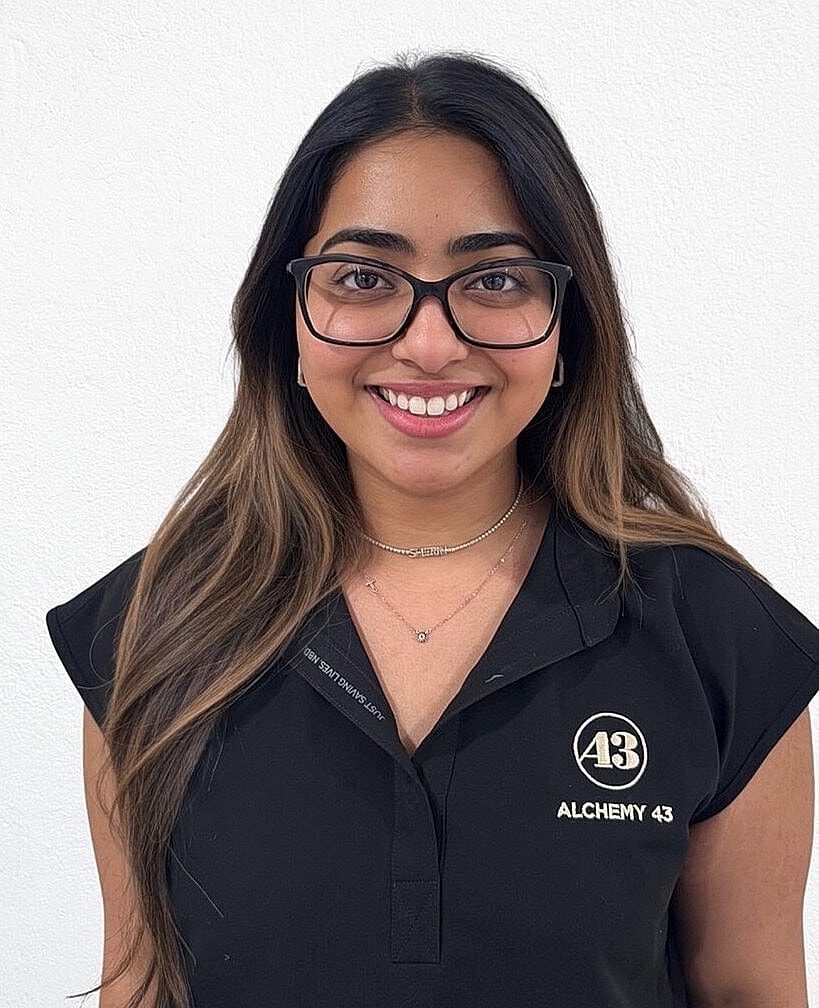 Smiling woman wearing glasses and black shirt.