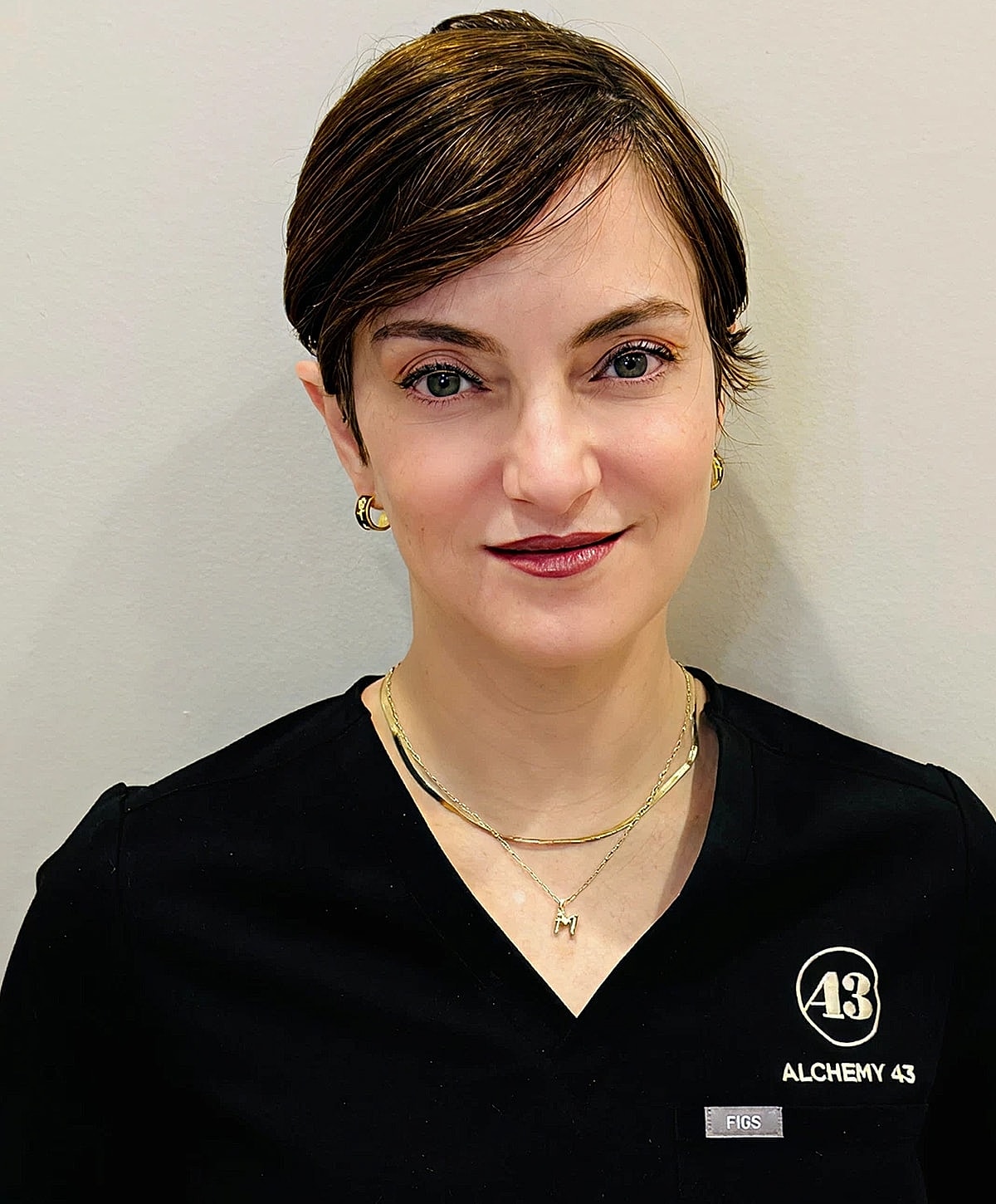 Woman in professional attire smiling at camera.