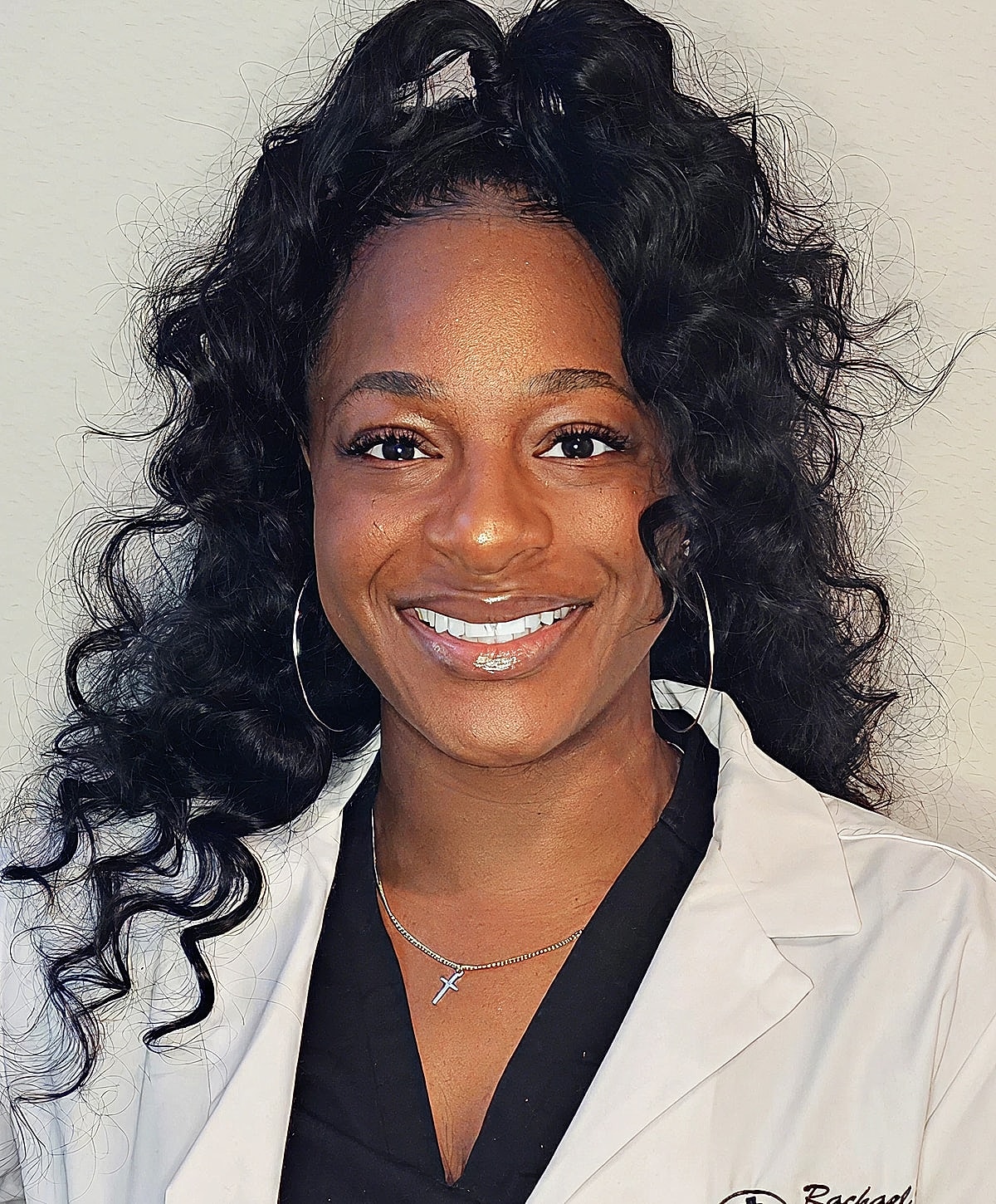 Smiling woman in a medical coat.