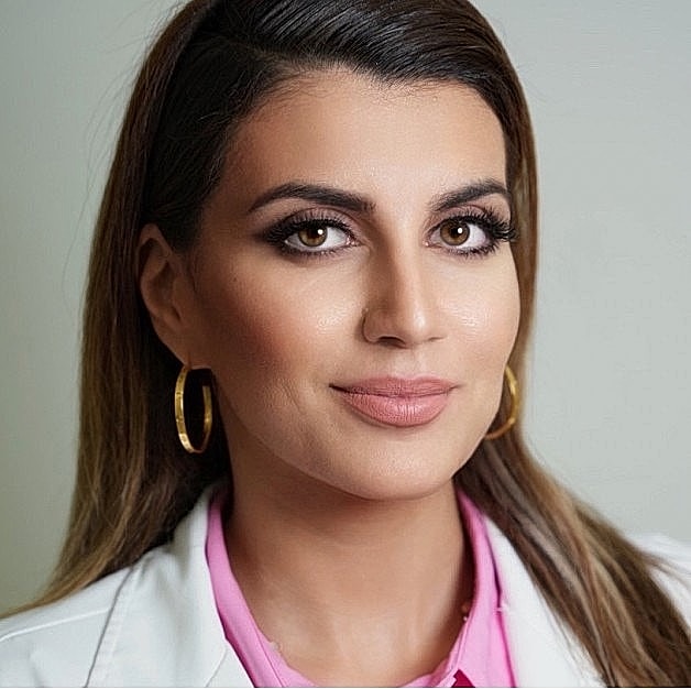 Portrait of a woman with long hair and earrings.